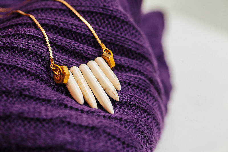 necklace on a purple sweater